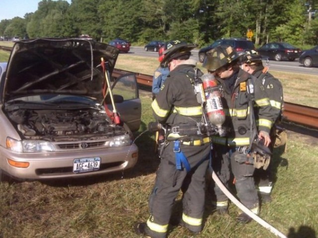 FF/EMT Geary, FF/EMT T. Bennett, and FF Silveira work at a car fire, Garden State Parkway South.